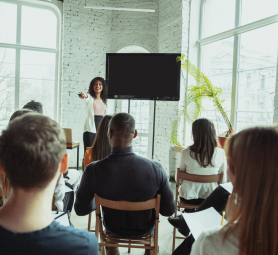 female-african-american-speaker-giving-presentation-hall-university-workshop_155003-3572